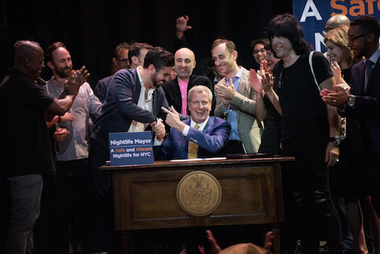 Mayor Bill de Blasio (center) celebrates with Councilmember Rafael Espinal in November after the mayor signed into law legislation to create an Office of Nightlife and Nightlife Advisory Board. Photo courtesy of NYC Mayor’s Office