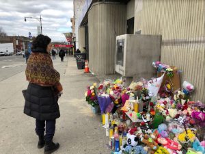 A pedestrian stops to view the makeshift memorial at the Park Slope corner where two small children lost their lives on March 5. Eagle photos by Paula Katinas