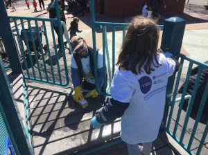 A volunteer from the Friends of William Sheridan Playground spruces up the South Williamsburg recreation area with help from a young friend. Photo courtesy of the City parks Foundation