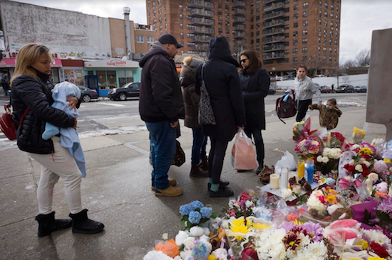 In this Thursday, March 8 photo, people gather at a sidewalk memorial for the two children who were killed in Park Slope. AP Photo/Mark Lennihan