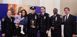 From left: Inspector Christine Bastendbeck, Officer of the Month Jason Cruz with his wife and daughter, Transit Captain Zahid Miller, Executive Officer Tyrice Miller, and Mark Gelbs.