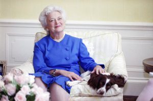 FILE - In this 1990 file photo, first lady Barbara Bush poses with her dog Millie in Washington. A family spokesman said Tuesday, April 17, 2018, that former first lady Barbara Bush has died at the age of 92. AP Photo/Doug Mills, File