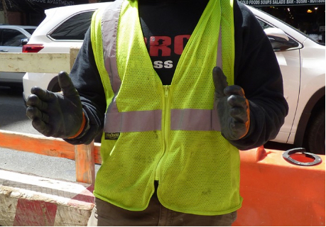 A worker at the 189 Montague St. construction site holds his arms out to indicate the size of a very large rat he saw while on the job. Photo by Mary Frost