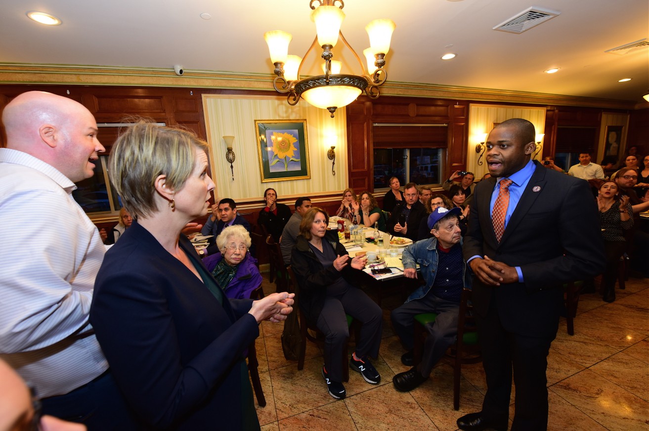 Bay Ridge Democrats President Chris McCreight tries to intervene as Congressional candidate Lutchi Gayot tried to ask Nixon about her recent controversial comments about marijuana as a form of reparations for blacks.
