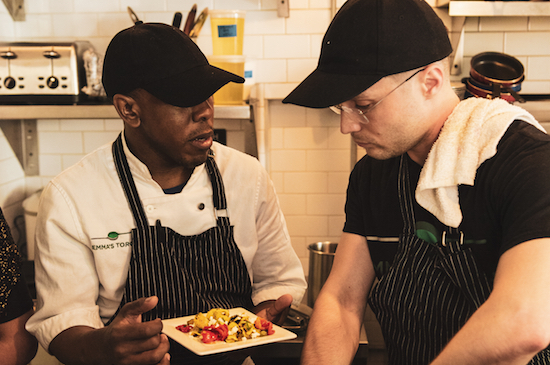 Emma’s Torch, a nonprofit that empowers refugees, asylees and survivors of human trafficking through culinary education, recently opened at 345 Smith St. Shown: Culinary director Alexander Harris speaks with a student. Photos by Giada Randaccio Skouras Sweeny
