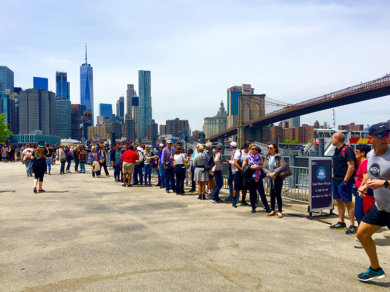Visitors queued up to ride the NYC Ferry last summer in Brooklyn Bridge Park. The city is taking steps to ease ferry congestion at the popular destination. Eagle photo by Lore Croghan