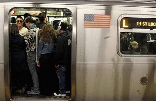 Passengers pack themselves into a crowded L Train in Brooklyn. AP Photo