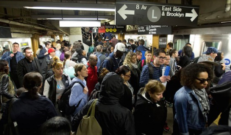 L train commuters work their way across a crowded subway platform. AP Photo/Mark Lennihan