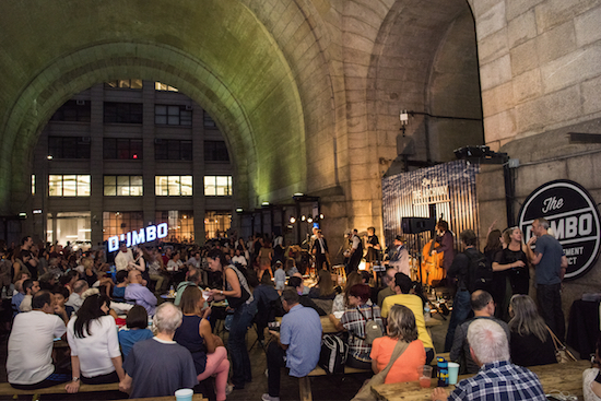 Guests enjoy the entertainment under the Manhattan Bridge in DUMBO. Photo by Julienne Schaer