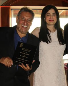 Mario Belluomo, seen here being honored by Sara Gozo and the Brooklyn Women’s Bar Association in 2017, served as a court officer for 40 years and as a photographer of the Brooklyn Eagle for 24. Photos courtesy of Mario Belluomo