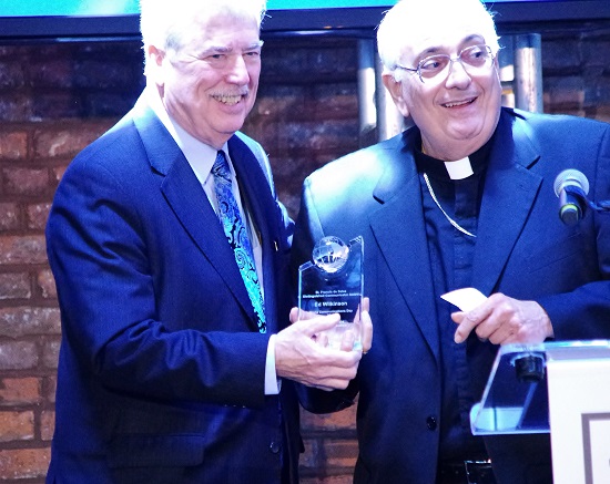 Ed Wilkinson, left, receives the St. Francis De Sales Distinguished Communicator Award from Bishop Nicholas DiMarzio. Eagle photos by Francesca N. Tate