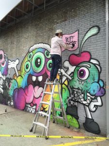 Buff Monster adds the finishing touches to his mural. Photos courtesy of Buff Monster