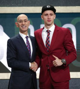 Dzanan Musa, right, of Bosnia and Herzegovina, poses with NBA Commissioner Adam Silver after he was picked 29th overall by the Brooklyn Nets during the NBA basketball draft in New York, Thursday, June 21, 2018. AP Photo/Kevin Hagen