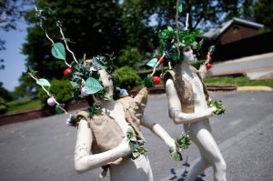 FIGMENT NYC 2018, a free interactive art event, is taking place on Governors Island this Saturday and Sunday. Shown: People dressed as trees walk through a past FIGMENT NYC on Governors Island. AP file photo/Jason DeCrow