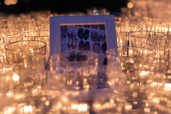 The candles surrounded photos of a memorial set up in San Juan that marked the deaths in Puerto Rico by empty pairs of shoes. Eagle photos by Paul Frangipane