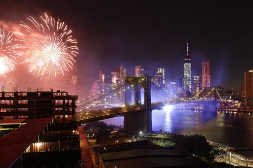 Fireworks light up the sky above the Brooklyn Bridge during Macy's Fourth of July fireworks show, Friday, July 4, 2014 in New York. AP Photo/Mark Lennihan
