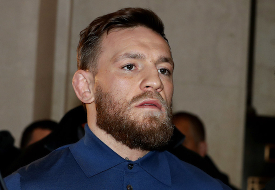 In this April 6 file photo, UFC star Conor McGregor, center, is escorted by New York Court Police officers after a hearing at the Brooklyn Criminal Court. McGregor is due in court amid plea negotiations to resolve charges stemming from a backstage melee at a New York City arena. The 30-year-old Irish fighter is expected to be joined Thursday  in Brooklyn by his 25-year-old friend and co-defendant Cian Cowley. AP Photo/Julio Cortez, File