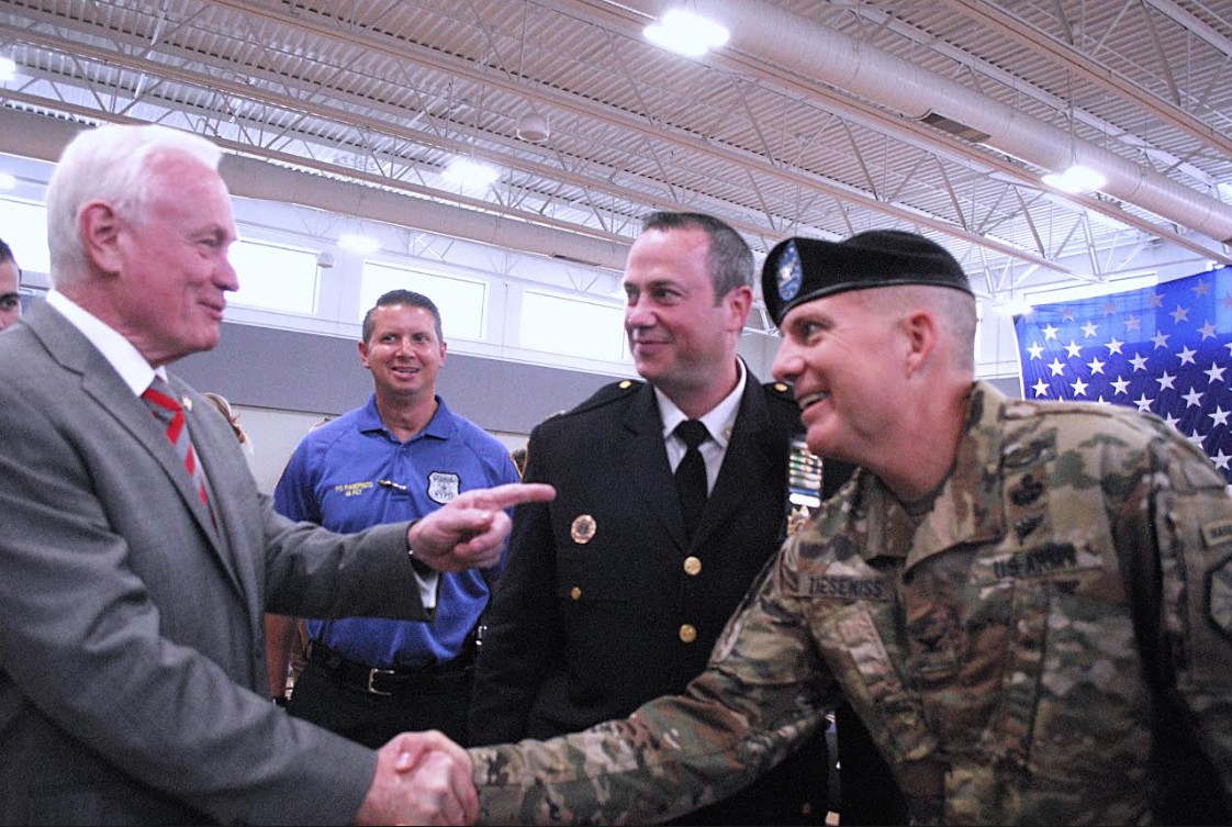 State Sen. Marty Golden shakes hands with incoming Fort Hamilton Army Base Commander Col. Andrew S. Zieseniss as Captain Robert Conwell of the 68th Precinct looks on.