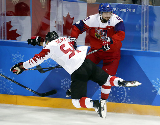 Maxim Noreau (56), of Canada, collides with Jan Kovar (43), of the Czech Republic, during the first period of the men's bronze medal hockey game at the 2018 Winter Olympics in Gangneung, South Korea, Saturday, Feb. 24, 2018. AP Photo/Julio Cortez