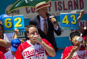 Joey Chestnut, left, and Matt Stonie compete in the Nathan's Famous Hotdog eating contest Tuesday, July 4, 2017, in Brooklyn, New York. Chestnut ate 72 hotdogs in 10 minutes to claim his 10th win. AP Photo/Michael Noble Jr.