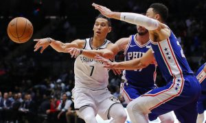 In this 2017, file photo, Nets guard Jeremy Lin passes the ball as Philadelphia 76ers guards Ben Simmons, right, and JJ Redick (17) defend during  a preseason game in Uniondale, N.Y. A person with knowledge of the details says the Nets have agreed to trade Lin to the Atlanta Hawks. The Nets made the move to ease an overcrowded point guard spot early Friday morning,  the person told The Associated Press on condition of anonymity because the trade had not been announced. AP Photo/Julie Jacobson, File