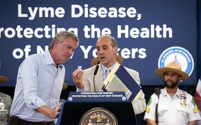 Mayor Bill de Blasio scowls at a tick in a jar held by Staten Island Borough President James Oddo at a press conference about the increasing incidence of Lyme disease in New York City. Last year, there were 381 reported cases in Brooklyn.  Photo by Michael Appleton/Mayoral Photography Office