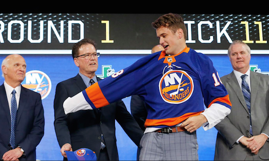 Isles team president and general manager Lou Lamoriello (left) looks on as the team’s first pick in the 2018 NHL Draft, Oliver Wahlstrom, puts on the Orange and Blue for the first time. AP Photo by Michael Ainsworth