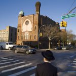In this April 26 photo, a Jewish boy walks into a yeshiva in Brooklyn.  Critics say dozens of ultra-Orthodox Jewish schools in New York run by Hasidic Jews do not provide enough instruction in English, math or other secular subjects to prepare students for the modern world.  A group that lobbies for more secular instruction in yeshivas filed a lawsuit Monday in federal court in Brooklyn over the matter.  AP Photo/Mark Lennihan