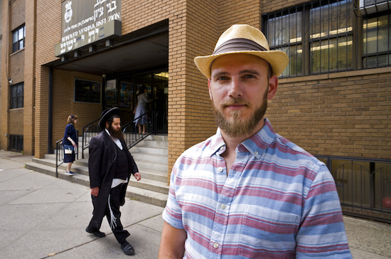 In this July 18 photo, Pesach Eisen poses in front of a yeshiva he attended as a child in Borough Park. Eisen, now 32, left his orthodox community in his late teens. Complaints that schools like Eisen's run by New York's strictly observant Hasidic Jews barely teach English, math, science or social studies have fueled a movement to demand stricter oversight by state and local educational authorities. AP Photo/Mark Lennihan