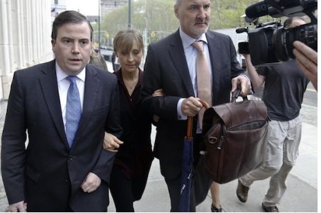 Actress Allison Mack, center, arrives with her legal team to Brooklyn Federal Court, in May. Mack was charged with coercing women who joined the organization into becoming a part of a secret sub-group where they were expected to act as “slaves” and engage in sex acts. Three more were arrested on Tuesday. AP Photo/Bebeto Matthews