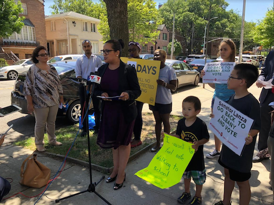 Deputy Schools Chancellor Cheryl Watson-Harris (at podium) was one of the speakers at a pro-camera rally outside P.S. 215 in Gravesend on July 5. Eagle photo by Paula Katinas