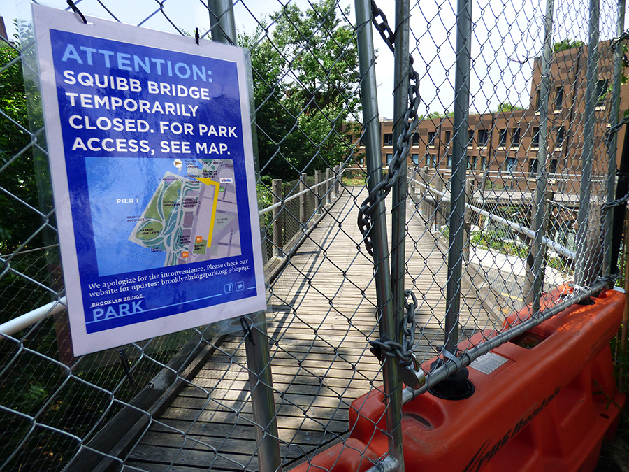 This sign directs pedestrians to the Old Fulton Street entrance to Brooklyn Bridge Park as the formerly bouncy Squibb Bridge has been closed once again.  Photo by Mary Frost