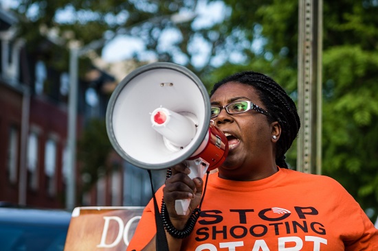 S.O.S. Bed-Stuy program manager Tiffany Murray speaks to a crowd on the corner of Van Buren Street and Tompkins Avenue. Eagle photos by Paul Frangipane
