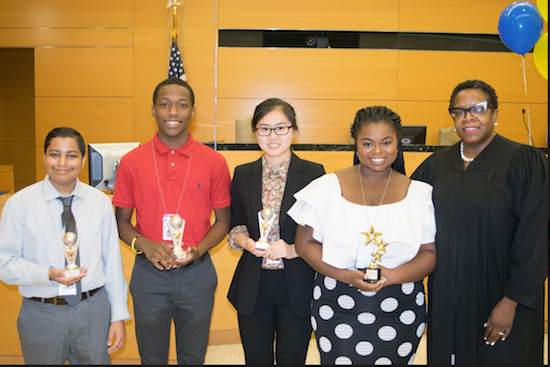 The 2018 Kings County Courts Student Youth Employment Program held its annual closing ceremony on Tuesday with an awards program. Pictured are this year’s Outstanding Workers (from left): Suraj Sahadeo, Farooq B. Ahmodu, Helen Hung and Patrice Brown with Hon. Robin Sheares. Eagle photos by Rob Abruzzese