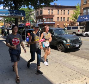 Three of the walkers finish a lap around the block during the marathon protest outside state Sen. Marty Golden’s office on Aug. 2. Eagle photos by Paula Katinas