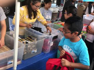 The backpack program draws hundreds of children each year to Reaching-Out Community Services in Bensonhurst. In addition to backpacks, children leave the event with school supplies. Photo courtesy of Reaching-Out Community Services Inc.