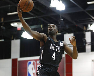 Brooklyn Nets' Theo Pinson grabs a rebound during the first half of the team's NBA summer league basketball game against the Orlando Magic on Friday, July 6, 2018, in Las Vegas. AP Photo/John Locher