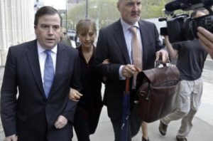 Actress Allison Mack, center, arrives with her legal team to Brooklyn Federal Court, in May. AP Photo/Bebeto Matthews