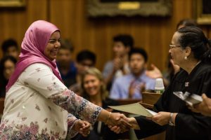 A new citizen shakes Chief Judge Dora Irizarry’s hand as she receives her certificate of citizenship. Eagle photos by Paul Frangipane