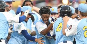 L.A. Woodard (center) is mobbed by teammates Sunday evening at MCU Park after drawing a walk to plate the winning the run in Brooklyn’s season-ending 5-4 victory over Staten Island. Photo Courtesy of Brooklyn Cyclones
