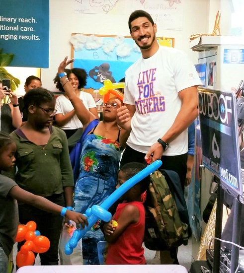 New York Knicks center Enes Kanter greets young fans at the Back-to-School Community Fair at the Flushing Family Residence. Photo courtesy of SCO Family of Services
