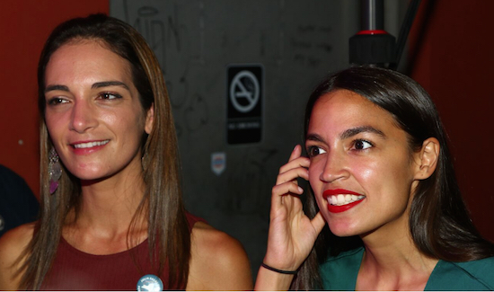 NYS Senatorial candidate Julia Salazar (left) and US Congressional candidate Alexandria Ocasio-Cortez chat with supporters at Our Wicked Lady event space. Eagle photos by Andy Katz