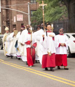 Clergy from around the Episcopal diocese and members of the Lions Club join the procession from Varick A.M.E. Zion Church, which has hosted the congregation during the construction of its new building. The procession headed up Patchen Ave. to Jefferson Ave., the site of the new church. Brooklyn Eagle photo by Francesca N. Tate