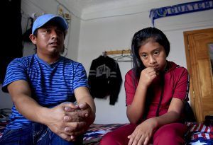 Tens of thousands of Brooklyn immigrants without green cards could be at risk if a new rule proposed by President Donald Trump goes into effect in two months. Shown: Guatemalan immigrants Manuel Marcelino Tzah, left, and his daughter Manuela Adriana, 11, sit inside their apartment during an interview hours after her release from immigrant detention in July in Brooklyn.  AP Photo/Bebeto Matthews