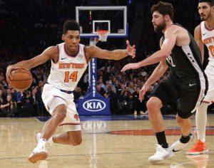 New York Knicks' Allonzo Trier (14) drives past Brooklyn Nets' Joe Harris (12) during the first half of an NBA basketball game Monday, Oct. 29, 2018, in New York. AP Photo/Frank Franklin II