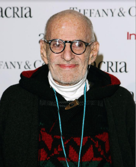 In this 2014 file photo, playwright Larry Kramer attends Acria's 19th Annual Holiday Dinner Benefit in New York. Bill Goldstein has been tapped to write the authorized biography of Kramer by Henry Holt and Company. The yet-untitled book will draw on interviews with Kramer; his husband David Webster; friends and foes; as well as papers in Kramer’s archives at Yale University. Photo by Donald Traill/Invision/AP, File