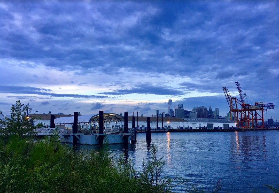 The NYC Ferry dock looks peaceful beneath the sheltering sky.