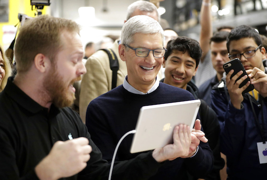 In this March 27, 2018, file photo Apple CEO Tim Cook smiles as he watches a demonstration on an iPad at an Apple educational event at Lane Technical College Prep High School in Chicago. New iPads and Mac computers are expected Tuesday, Oct. 30, as part of an Apple event in New York. AP Photo/Charles Rex Arbogast, File