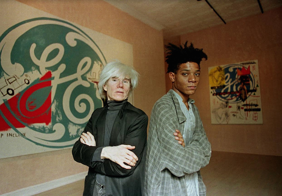 Jean-Michel Basquiat (at right), shown in this 1985 photo with fellow artist Andy Warhol, is buried in Green-Wood Cemetery. AP File Photo/Richard Drew