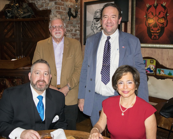 The Kings County Housing Court Bar Association hosted Helene Blank (sitting right) and her partner Scott Star (sitting left) during its monthly meeting. Also pictured are KCHCBA members Alan Redner (left) and Hal Rose. Eagle photos by Rob Abruzzese